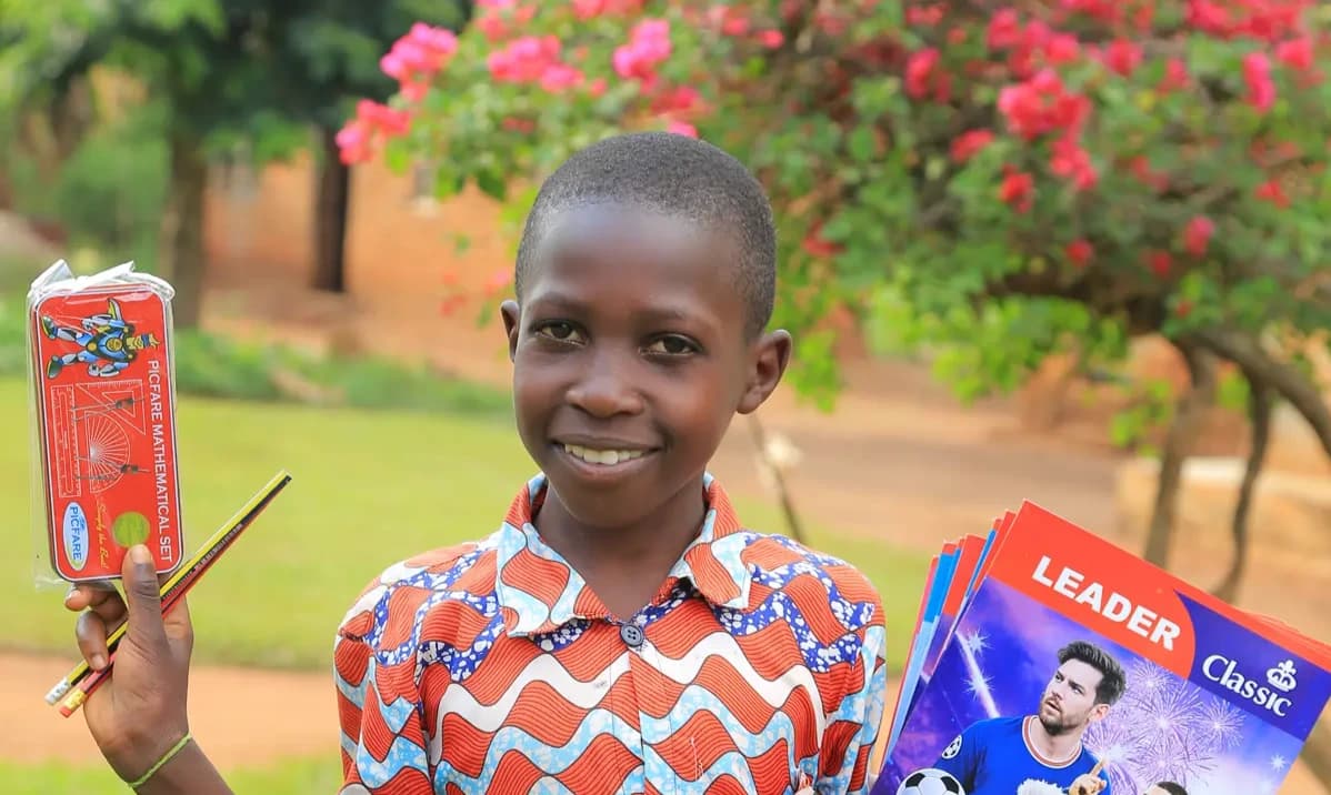 Simon smiling with his new books