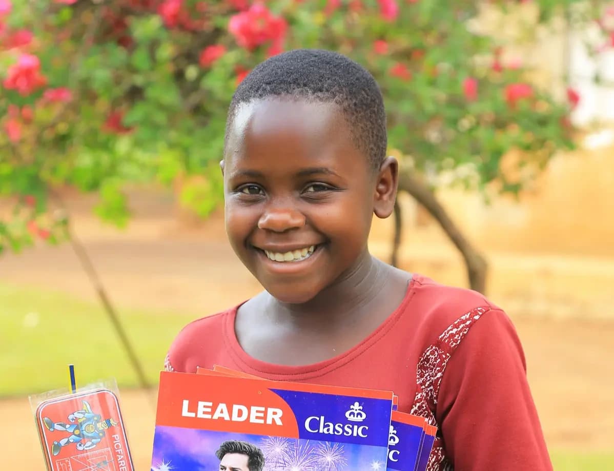 Tracy smiling with books